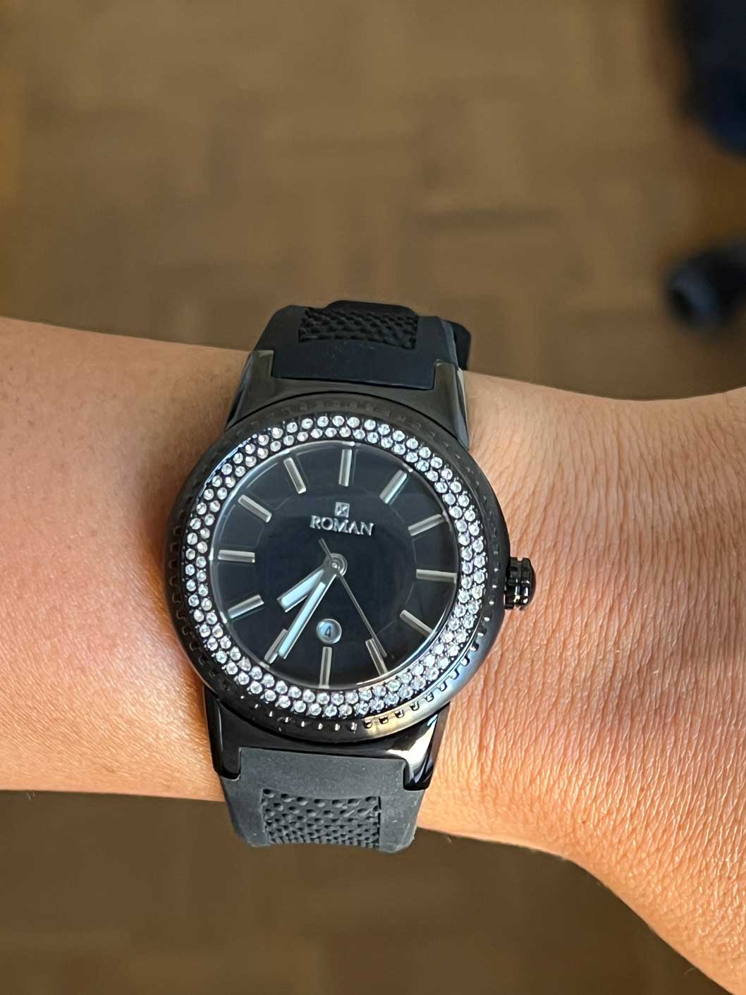 Roman watch, black and white with black rubber strap.