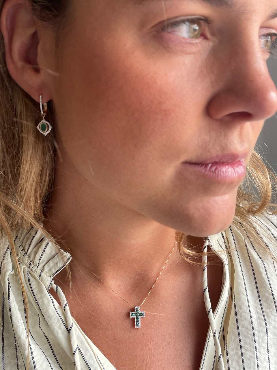 VELARA cross in 14k yellow gold with diamonds and emeralds