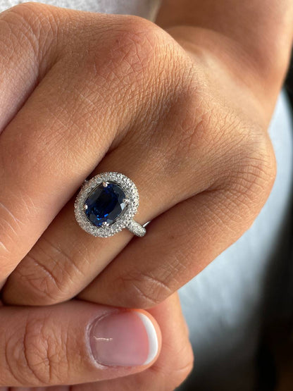 POIO ring with sapphire center and diamonds in 18k white gold.