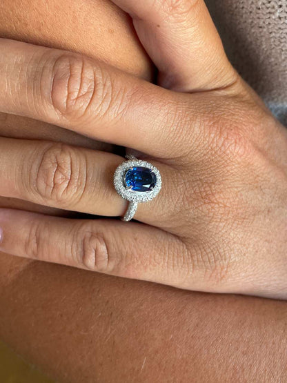 POIO ring with sapphire center and diamonds in 18k white gold.