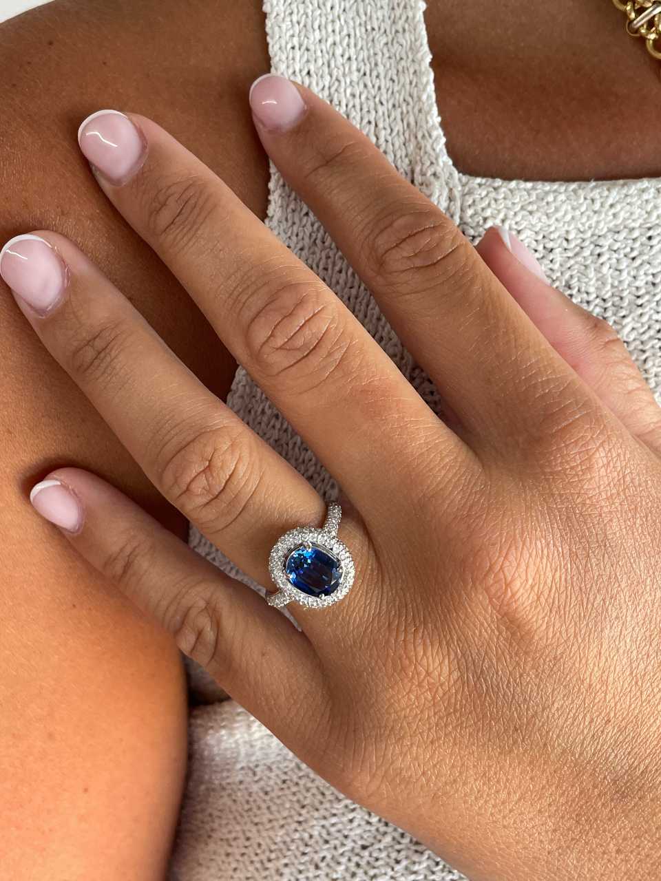 POIO ring with sapphire center and diamonds in 18k white gold.