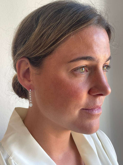 LIBIA long rosette diamond earrings in 18-karat white gold