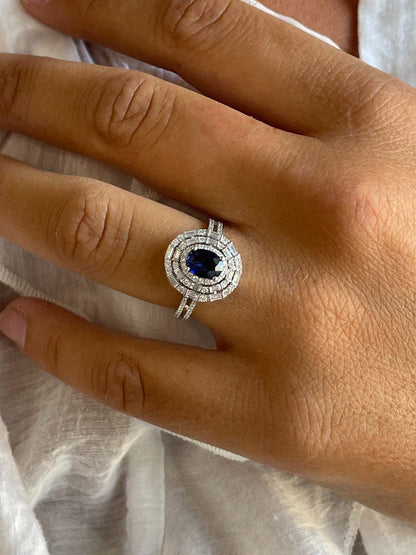 POIO ring with sapphire center and diamonds in 18k white gold.